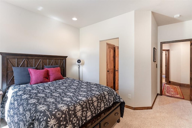 carpeted bedroom featuring baseboards and recessed lighting