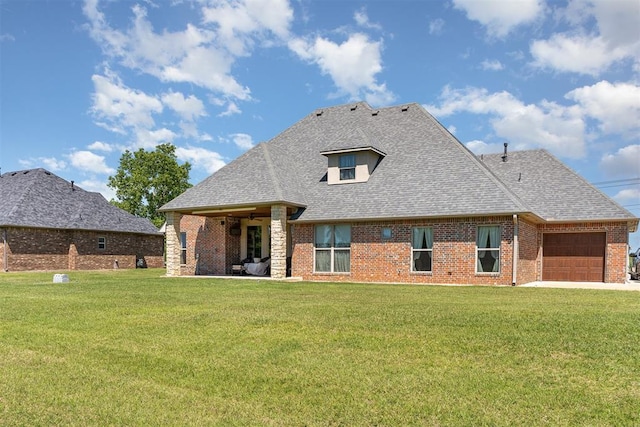 rear view of property featuring an attached garage, roof with shingles, a lawn, and brick siding
