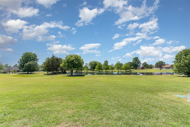 view of home's community featuring a water view and a yard