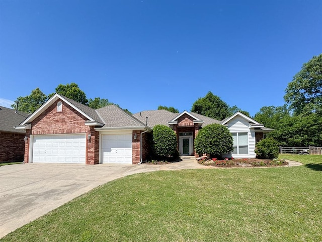 3424 Teton Ct, Norman, OK 73072 - view of front of home with an attached garage, brick siding, concrete driveway, and roof with shingles