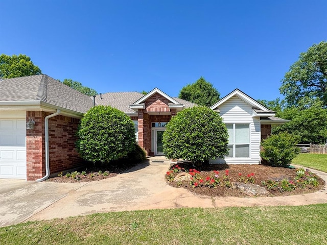 3424 Teton Ct, Norman, OK 73072 - view of front facade featuring brick siding, a garage, and roof with shingles