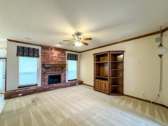 3424 Teton Ct, Norman, OK 73072 - unfurnished living room with ceiling fan, light colored carpet, a brick fireplace, baseboards, and ornamental molding