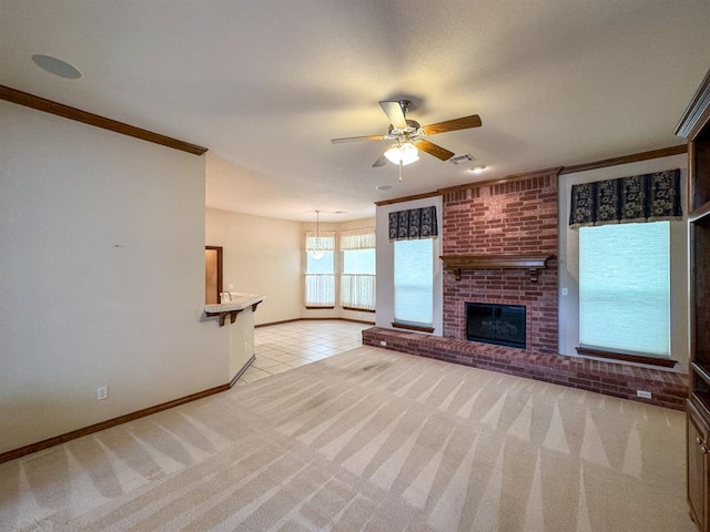 3424 Teton Ct, Norman, OK 73072 - unfurnished living room featuring light colored carpet, ornamental molding, a ceiling fan, baseboards, and a fireplace
