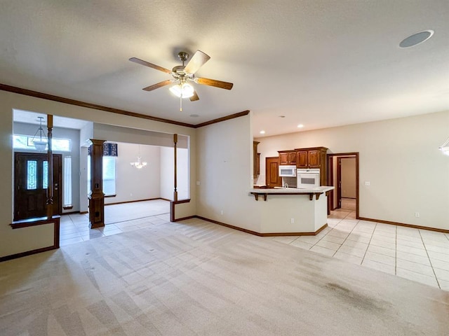 3424 Teton Ct, Norman, OK 73072 - unfurnished living room with light tile patterned flooring, baseboards, a ceiling fan, ornamental molding, and light carpet