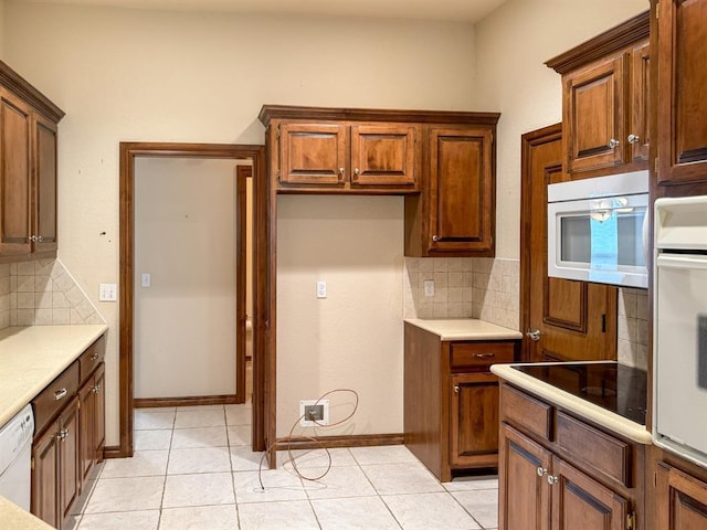3424 Teton Ct, Norman, OK 73072 - kitchen with white appliances, backsplash, light countertops, and light tile patterned flooring