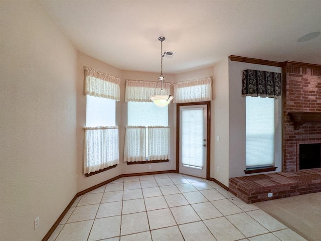 3424 Teton Ct, Norman, OK 73072 - unfurnished dining area featuring healthy amount of natural light, baseboards, light tile patterned floors, and a brick fireplace