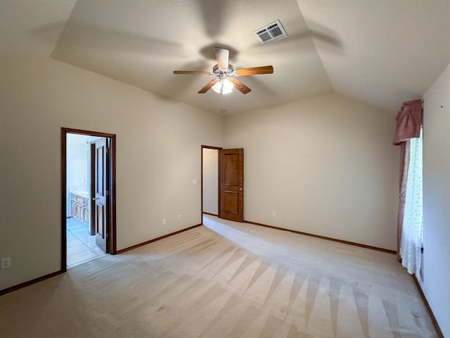 3424 Teton Ct, Norman, OK 73072 - unfurnished bedroom featuring light colored carpet, vaulted ceiling, baseboards, ceiling fan, and connected bathroom