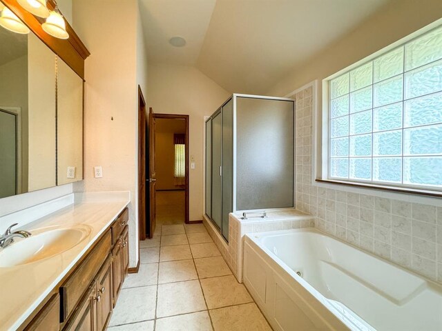 3424 Teton Ct, Norman, OK 73072 - bathroom featuring vanity, a tub with jets, a stall shower, tile patterned flooring, and vaulted ceiling