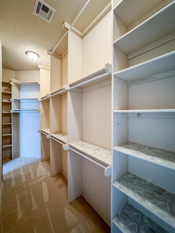 3424 Teton Ct, Norman, OK 73072 - walk in closet featuring light colored carpet