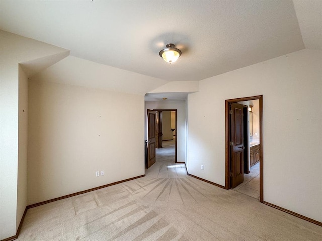 3424 Teton Ct, Norman, OK 73072 - empty room with lofted ceiling, light colored carpet, and baseboards