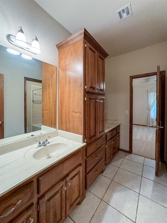 3424 Teton Ct, Norman, OK 73072 - bathroom with vanity, tile patterned flooring, and a textured ceiling