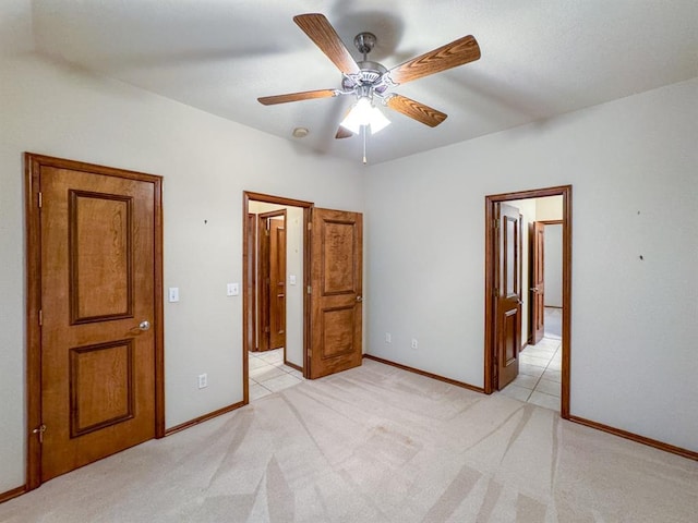 3424 Teton Ct, Norman, OK 73072 - unfurnished bedroom with baseboards, light carpet, and ceiling fan