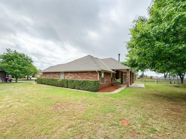 3424 Teton Ct, Norman, OK 73072 - view of home's exterior featuring brick siding and roof with shingles