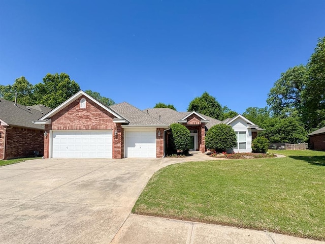 3424 Teton Ct, Norman, OK 73072 - view of front of house featuring an attached garage, brick siding, and concrete driveway