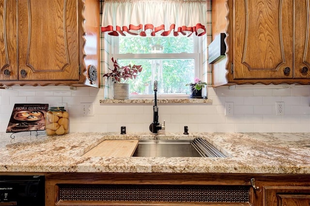 5708 NW 87th St, Oklahoma City, OK 73132 - kitchen with brown cabinetry, decorative backsplash, a sink, light stone counters, and dishwasher