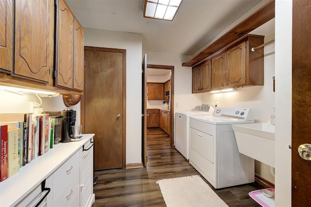 5708 NW 87th St, Oklahoma City, OK 73132 - laundry area featuring washer and clothes dryer, cabinet space, and dark wood-style floors