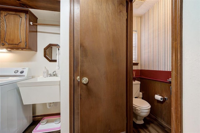 5708 NW 87th St, Oklahoma City, OK 73132 - laundry room with washer / clothes dryer and dark wood-style floors