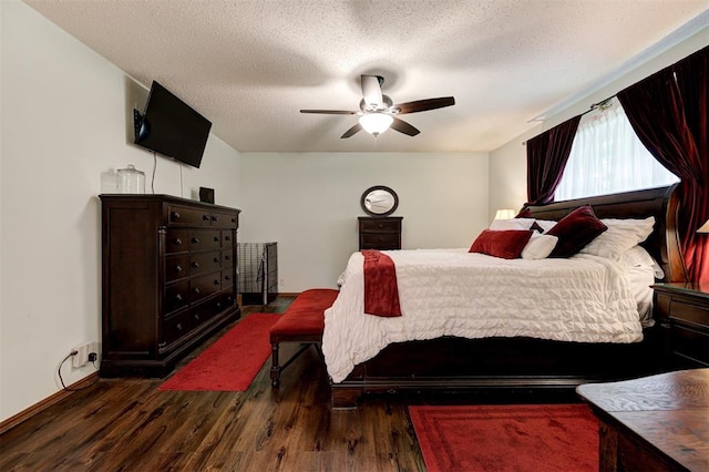 5708 NW 87th St, Oklahoma City, OK 73132 - bedroom with dark wood-style flooring, a ceiling fan, a textured ceiling, and baseboards