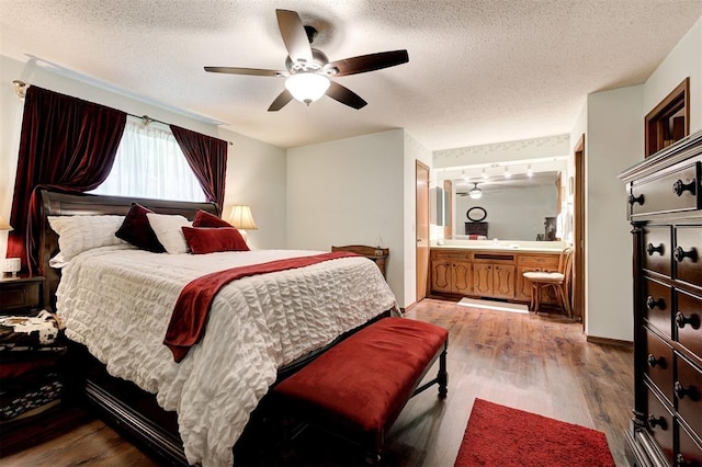 5708 NW 87th St, Oklahoma City, OK 73132 - bedroom with a textured ceiling, wood finished floors, connected bathroom, and a ceiling fan