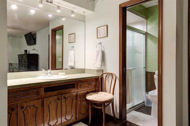 5708 NW 87th St, Oklahoma City, OK 73132 - full bathroom featuring toilet, vanity, a shower stall, and wood finished floors