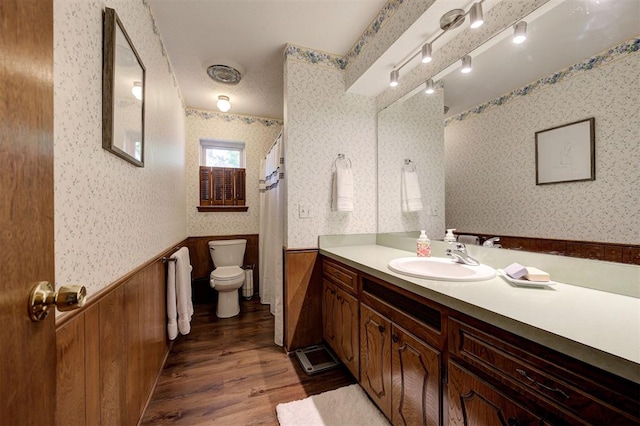 5708 NW 87th St, Oklahoma City, OK 73132 - bathroom featuring wallpapered walls, wainscoting, wood finished floors, toilet, and vanity