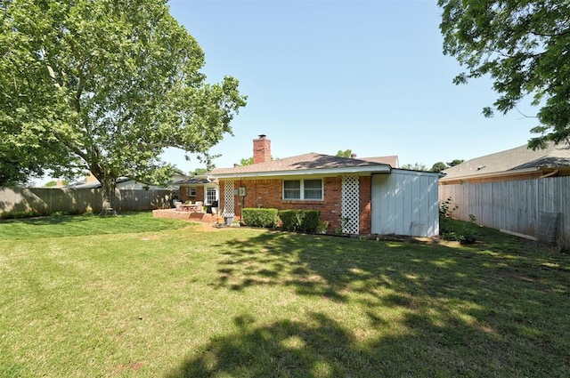 5708 NW 87th St, Oklahoma City, OK 73132 - rear view of property featuring a chimney, brick siding, and a patio