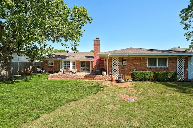 5708 NW 87th St, Oklahoma City, OK 73132 - rear view of house with a chimney, a patio, and brick siding