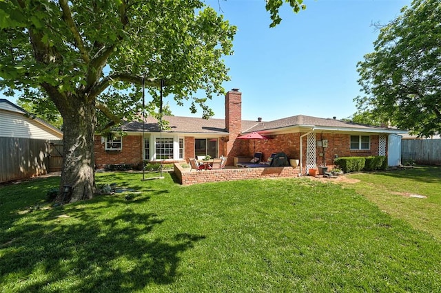 5708 NW 87th St, Oklahoma City, OK 73132 - rear view of house with a chimney, brick siding, and a patio area