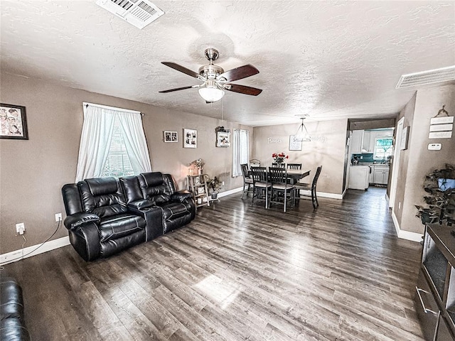 206 N Donald Ave, El Reno, OK 73036 - living room with wood finished floors, plenty of natural light, and a textured ceiling