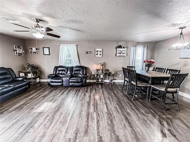 206 N Donald Ave, El Reno, OK 73036 - dining space featuring baseboards, wood finished floors, a ceiling fan, a textured ceiling, and a chandelier