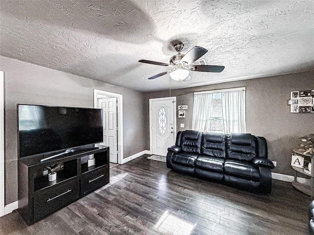 206 N Donald Ave, El Reno, OK 73036 - living room with dark wood-style flooring, baseboards, a ceiling fan, and a textured ceiling