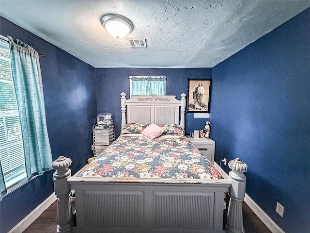 206 N Donald Ave, El Reno, OK 73036 - bedroom with baseboards, a textured ceiling, and a textured wall