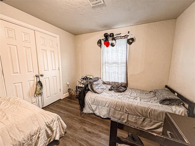 206 N Donald Ave, El Reno, OK 73036 - bedroom with dark wood-type flooring and a textured ceiling