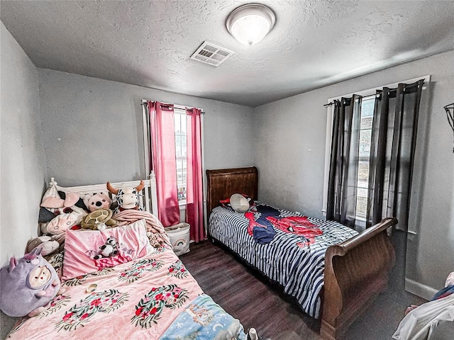 206 N Donald Ave, El Reno, OK 73036 - bedroom with wood finished floors and a textured ceiling