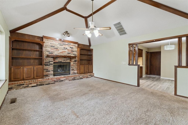 1104 Cedar Hill Pl, Oklahoma City, OK 73110 - unfurnished living room featuring carpet flooring, ceiling fan, baseboards, beamed ceiling, and a fireplace