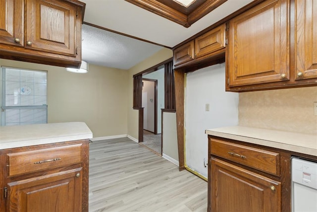 1104 Cedar Hill Pl, Oklahoma City, OK 73110 - kitchen with brown cabinetry, light wood finished floors, light countertops, dishwasher, and baseboards