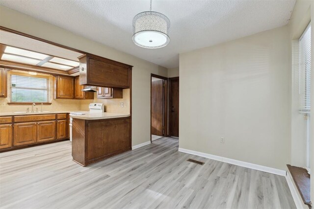 1104 Cedar Hill Pl, Oklahoma City, OK 73110 - kitchen with light wood-style floors, light countertops, a sink, range, and baseboards