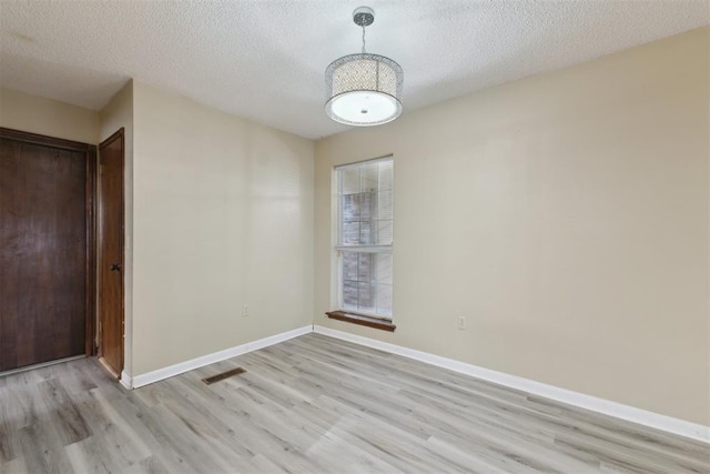 1104 Cedar Hill Pl, Oklahoma City, OK 73110 - spare room featuring light wood-style flooring, a textured ceiling, and baseboards