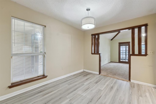 1104 Cedar Hill Pl, Oklahoma City, OK 73110 - spare room featuring light wood-type flooring, a textured ceiling, and baseboards