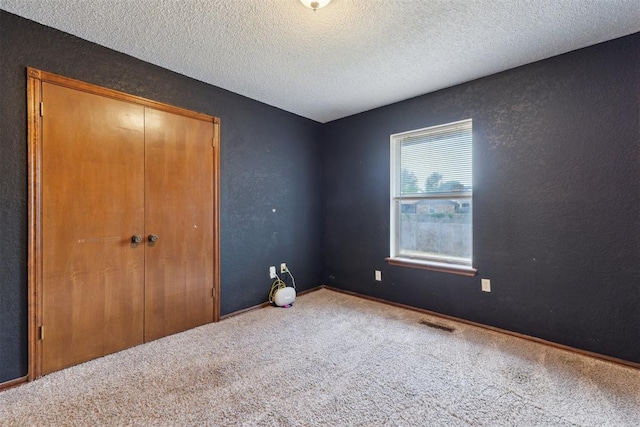 1104 Cedar Hill Pl, Oklahoma City, OK 73110 - unfurnished bedroom featuring carpet, a closet, and a textured ceiling