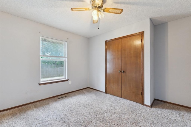 1104 Cedar Hill Pl, Oklahoma City, OK 73110 - unfurnished bedroom with carpet floors, a closet, baseboards, ceiling fan, and a textured ceiling