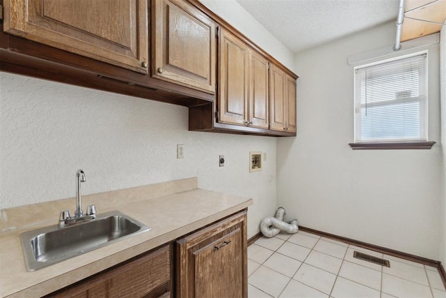 1104 Cedar Hill Pl, Oklahoma City, OK 73110 - clothes washing area with electric dryer hookup, cabinet space, washer hookup, baseboards, and a textured ceiling