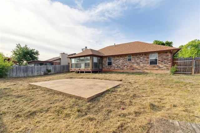 1104 Cedar Hill Pl, Oklahoma City, OK 73110 - back of property featuring a patio, a sunroom, a shingled roof, and brick siding