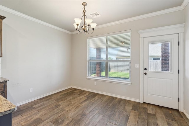 8345 NW 137th St, Oklahoma City, OK 73142 - unfurnished dining area with a chandelier, wood finished floors, ornamental molding, healthy amount of natural light, and baseboards