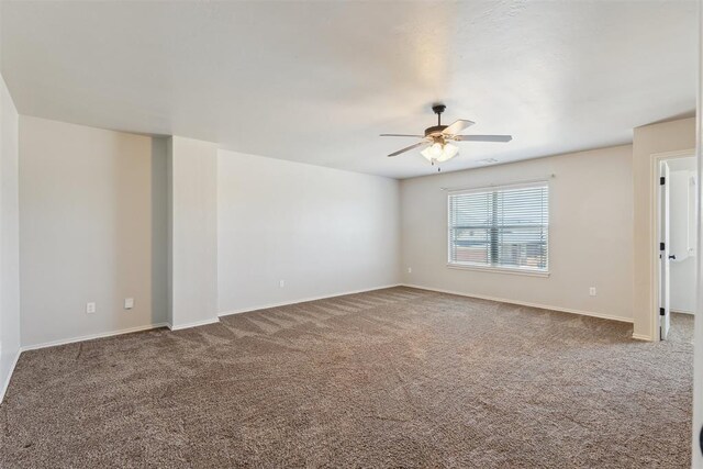 8345 NW 137th St, Oklahoma City, OK 73142 - spare room with a ceiling fan, carpet floors, and baseboards