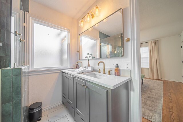 1017 Dean Pl, Oklahoma City, OK 73117 - bathroom featuring double vanity, baseboards, and a shower