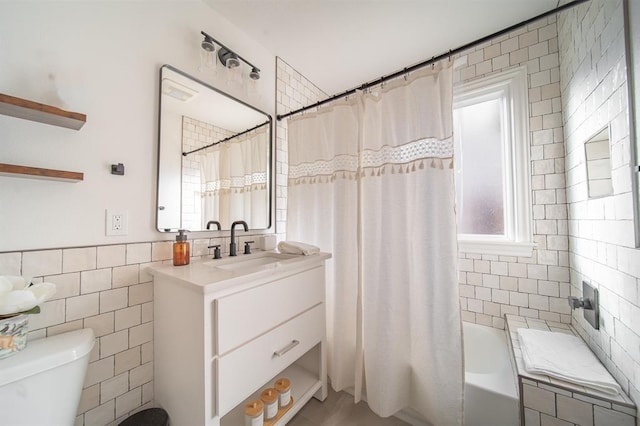 1017 Dean Pl, Oklahoma City, OK 73117 - bathroom featuring tile walls, toilet, vanity, and shower / tub combo
