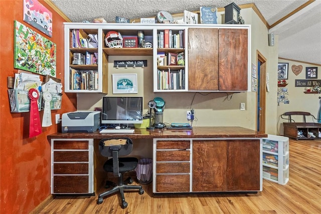 office area with crown molding, a textured ceiling, wood finished floors, and built in study area