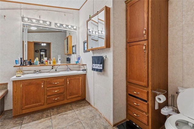 full bathroom featuring toilet, double vanity, and tile patterned floors