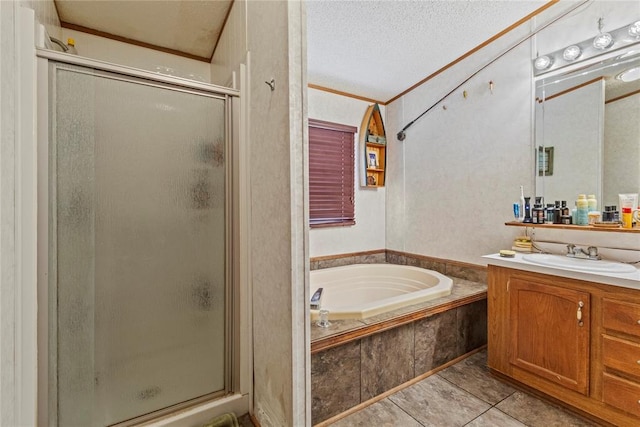 full bath featuring a stall shower, vanity, a textured ceiling, a bath, and ornamental molding